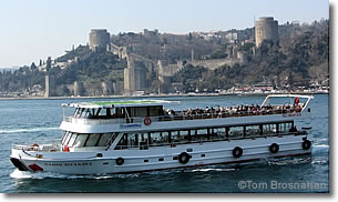 Bosphorus tour boat at Rumeli Hisarı fortress, Bosphorus, Istanbul, Turkey