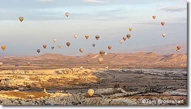 Hot-air balloons crowd the sky over Cappadocia, Turkey