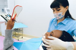 dental patient looking at her teeth
