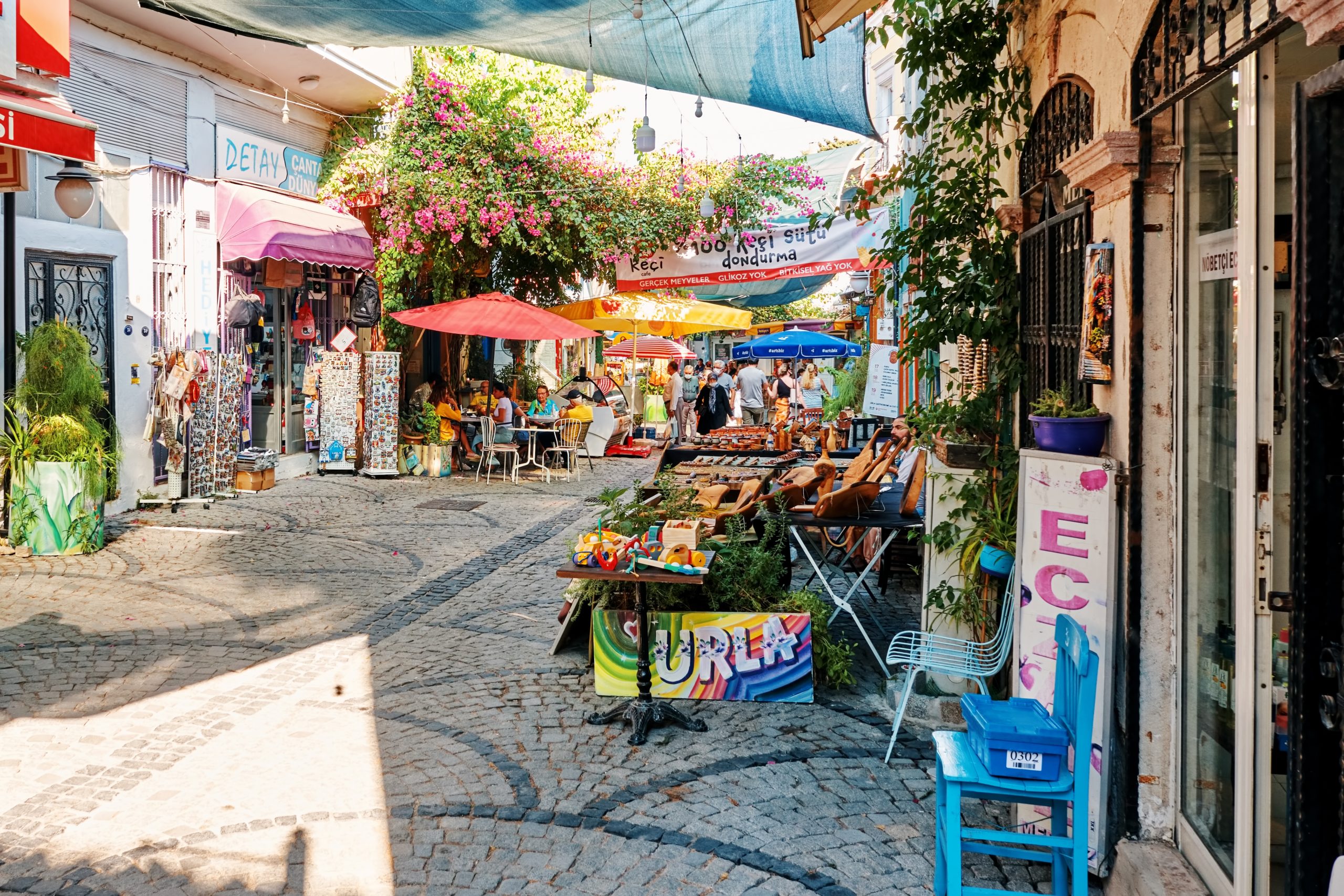 Urla,,Turkey,-,September,,2021:,Souvenir,Shops,,Cafes,And,People Urla,,Turkey,-,September,,2021:,Souvenir,Shops,,Cafes,And,People